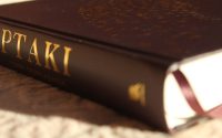 A close up of a book on a bed